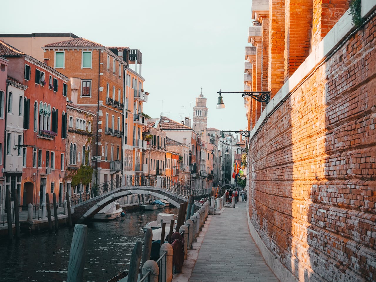 Charming view of a canal in Venice with colorful buildings and a bridge.